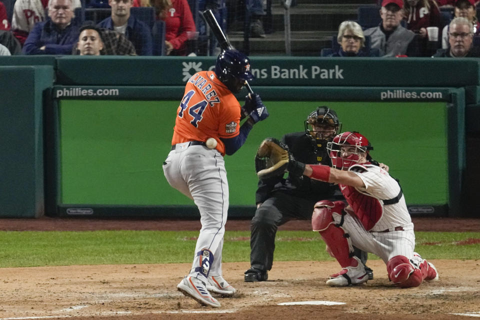 Houston Astros' Yordan Alvarez gets hit by a pitch scoring Chas McCormick during the fifth inning in Game 4 of baseball's World Series between the Houston Astros and the Philadelphia Phillies on Wednesday, Nov. 2, 2022, in Philadelphia. (AP Photo/Matt Rourke)