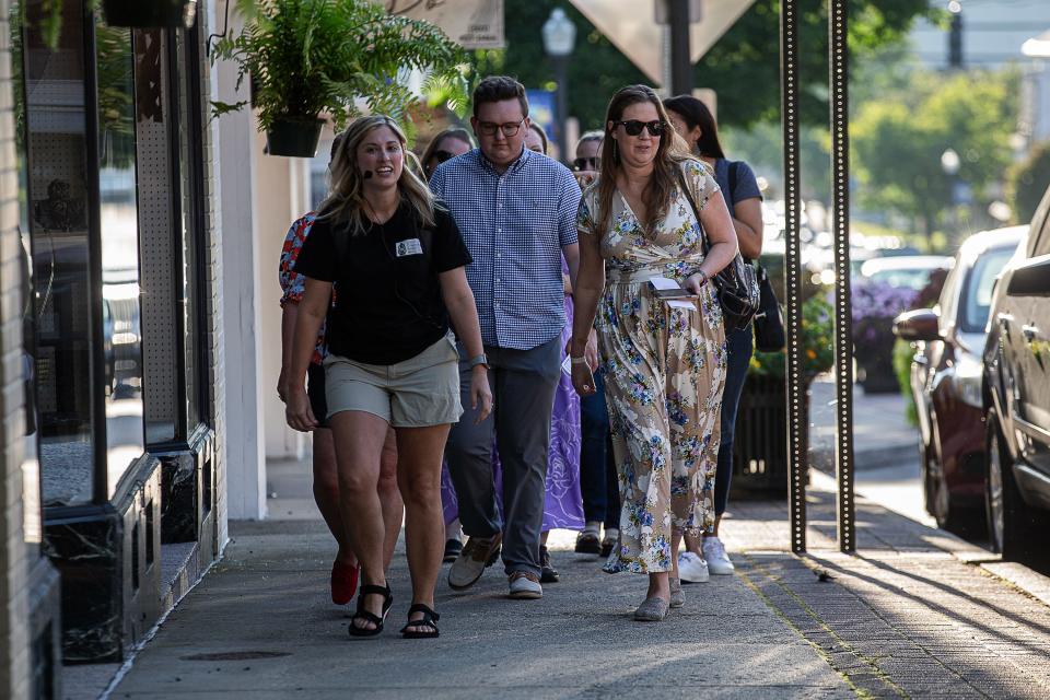Paranormal Researcher Caitlin Zoeller, left, led a Shelbyville Ghost Tour group to haunted locations down Main St. in downtown Shelbyville, Ky. Aug. 30, 2023