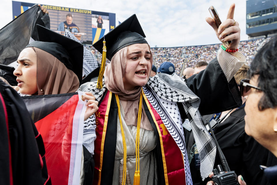 Pro-Palestinian protesters demonstrate during the University of Michigan's Spring 2024 Commencement Ceremony at Michigan Stadium in Ann Arbor, Mich., on Saturday, May 4, 2024.( Jacob Hamilton/Ann Arbor News via AP)