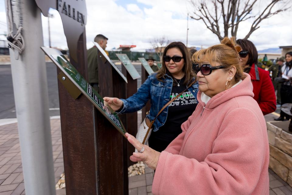 Family members of fallen Border Patrol Agents look for the name of the fallen agent's names after a ceremony where the El Paso Sector unveiled a memorial honoring fallen agents on Wednesday, Jan. 24, at the El Paso Sector Headquarters.