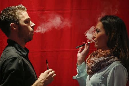 People use electronic vaporizers with cannabidiol (CBD)-rich hemp oil while attending the International Cannabis Association Convention in New York, October 12, 2014. REUTERS/Eduardo Munoz