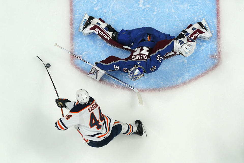 Colorado Avalanche goaltender Darcy Kuemper (35) makes a save against Edmonton Oilers right wing Zack Kassian (44) during the second period in Game 1 of the NHL hockey Stanley Cup playoffs Western Conference finals Tuesday, May 31, 2022, in Denver. (AP Photo/Jack Dempsey)