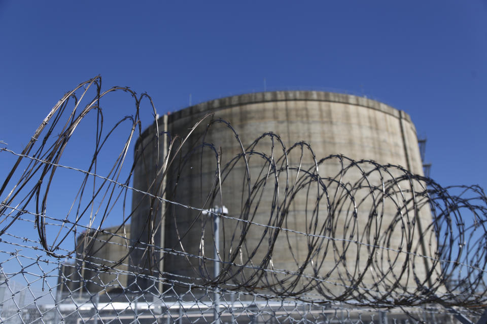 Barbed wire surrounds structures filled with liquefied natural gas at the Cameron LNG export facility in Hackberry, La., on Thursday, March 31, 2022. The export facility is one of several on the Gulf Coast that help get natural gas from the Permian Basin and other parts of Texas to Asia, Europe and other continents. Demand for natural gas worldwide has been soaring since Russia, another major natural gas exporter, invaded Ukraine. (AP Photo/Martha Irvine)