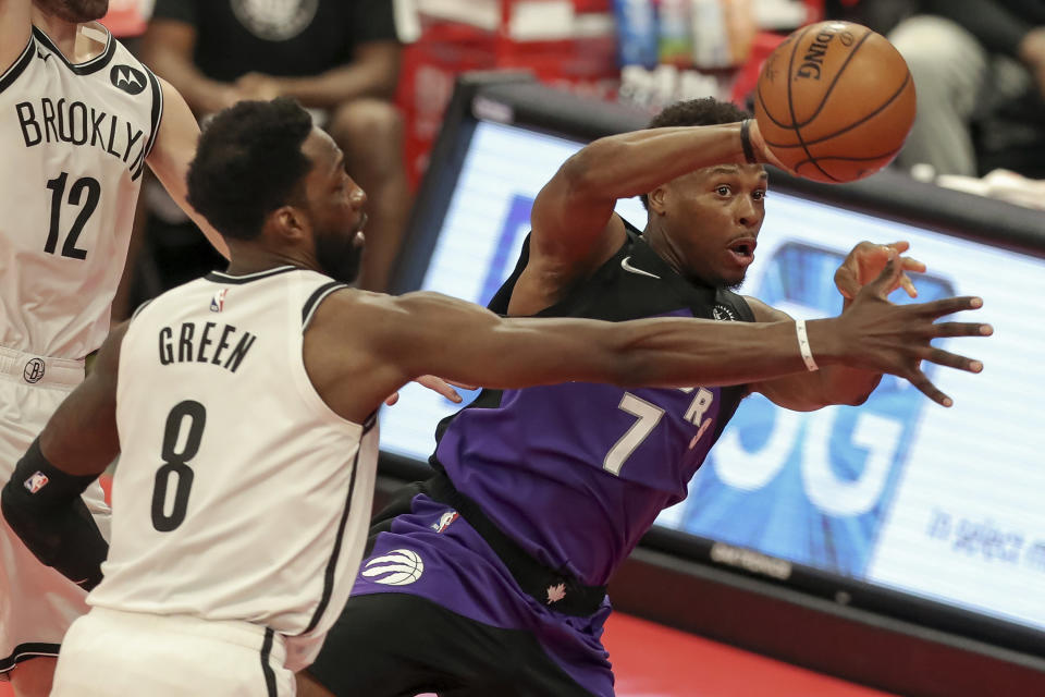Toronto Raptors' Kyle Lowry (7) passes around Brooklyn Nets' Jeff Green during the second half of an NBA basketball game Wednesday, April 21, 2021, in Tampa, Fla. (AP Photo/Mike Carlson)