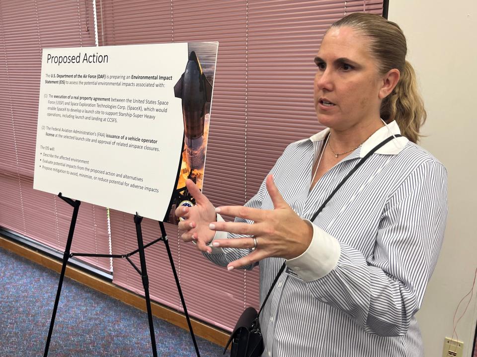 Michelle Rau of Jacobs Engineering discusses SpaceX's Starship proposals with attendees during Tuesday's public meeting at the Catherine Schweinsberg Rood Central Library in Cocoa.