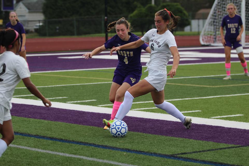 Clarkstown North's Alexa Buxbaum (4, left) battles Clarkstown South's Waverly Meyers (6, right) for possession during a game on Oct. 16, 2021.