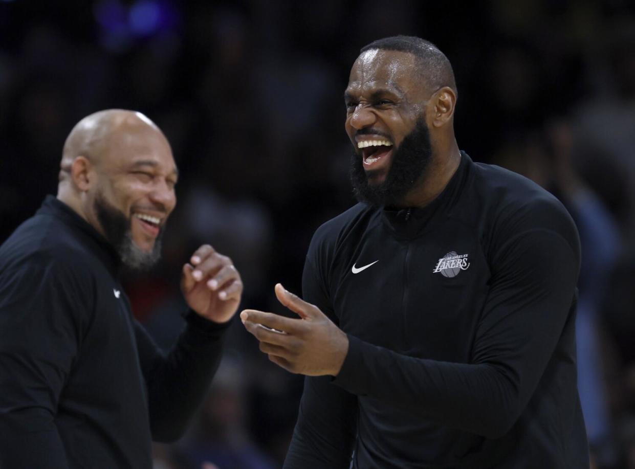 Lakers coach Darvin Ham, left, and forward LeBron James share a laugh.