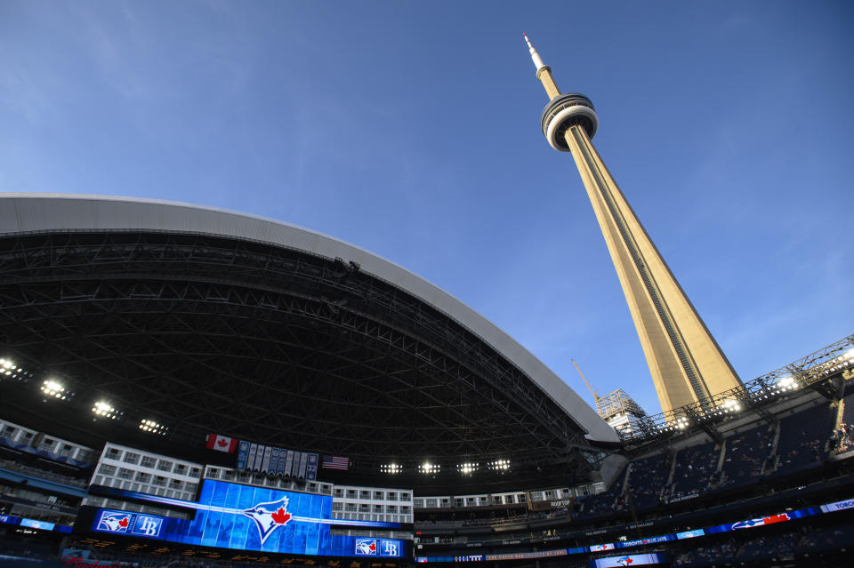 The CN Tower is seen through an open Rogers Centre dome before a baseball game between the Tampa Bay Rays and the Toronto Blue Jays on Friday, April 14, 2023, in Toronto. (Christopher Katsarov/The Canadian Press via AP)