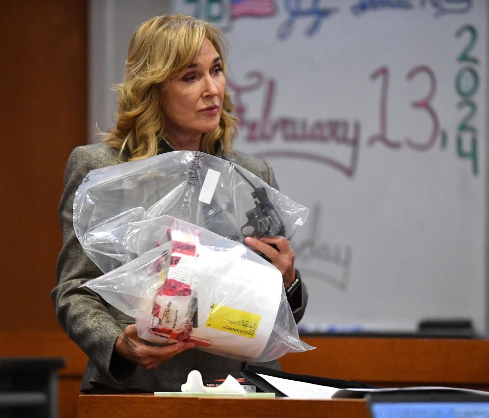 Assistant State Attorney Karen Fraivillig holds a revolver that was recovered from Sarasota Bay near Whitaker Park, during testimony in court Tuesday. Nyquan Priester has been charged with 2nd degree murder in connection with a shooting at Ackerman Park in December 2021.