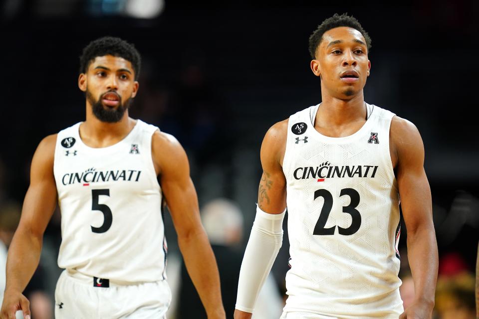 Cincinnati Bearcats guard David DeJulius (5) and Cincinnati Bearcats guard Mika Adams-Woods (23) return to the court after a timeout in the first half of an NCAA menÕs college basketball game against the Southern Methodist Mustangs, Thursday, Jan. 6, 2022, at Fifth Third Arena in Cincinnati.