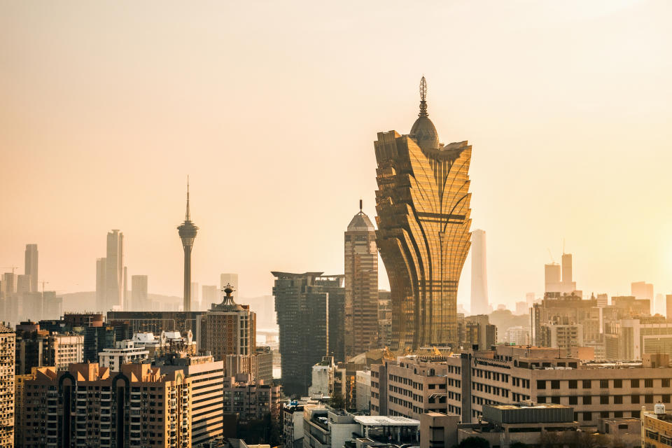 Skyline with distinctive tower among modern buildings at dusk