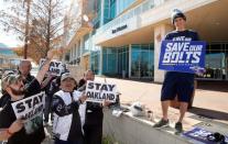 Jan 12, 2016; Houston, TX, USA; San Diego Chargers fan Richard Farley , right, along with Raiders fans hold signs supporting their teams while owners met at the 2016 NFL owners meeting at the Westin Houston. Mandatory Credit: Thomas B. Shea-USA TODAY Sports