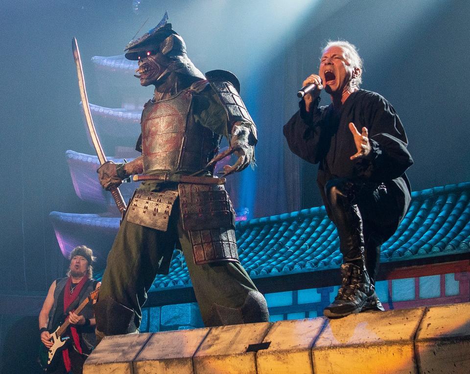 Iron Maiden lead singer Bruce Dickinson performs next to the band's long-time mascot Eddie, dressed as a samurai on this tour, at the DCU Center Monday.