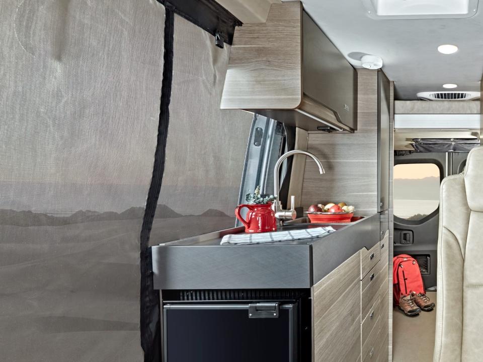 the 2022 Jayco Terrain's passenger seats and kitchen