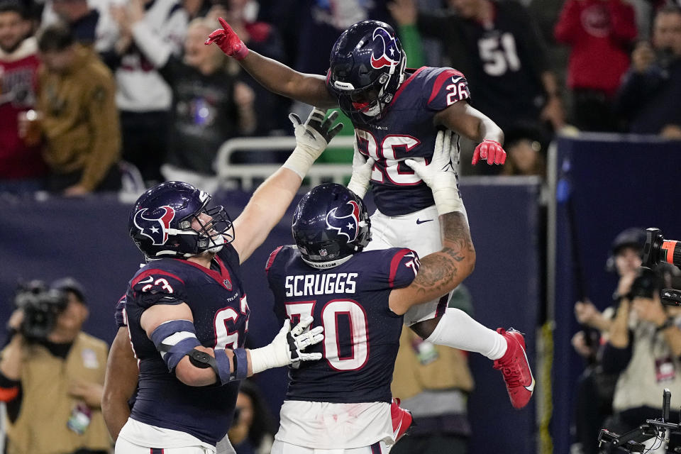 Houston Texans running back Devin Singletary celebrates after scoring against the Cleveland Browns during the second half of an NFL wild-card playoff football game Saturday, Jan. 13, 2024, in Houston. (AP Photo/David J. Phillip)