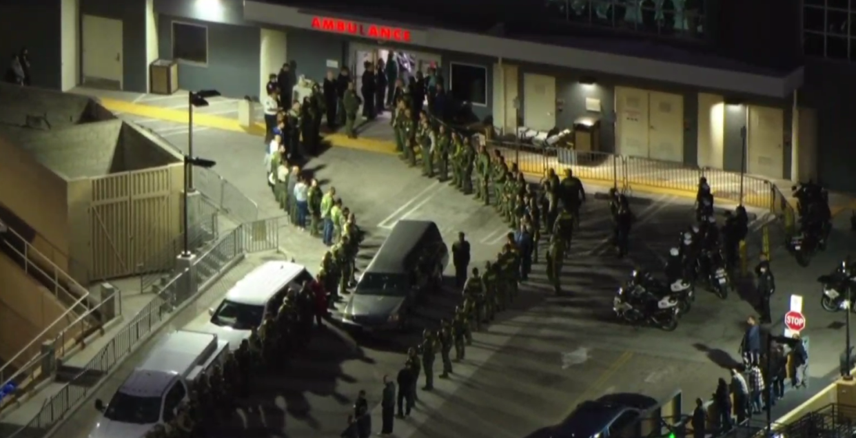 Members of the Riverside County Sheriff's Department line up outside a hospital to pay their respects to a deputy who was shot and killed during a traffic stop in Jurupa Valley, California, on Dec. 29, 2022.  / Credit: CBS Los Angeles