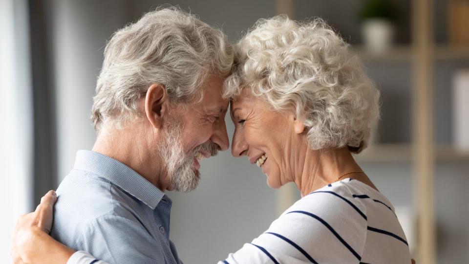 smiling mature husband and wife share romantic moment together