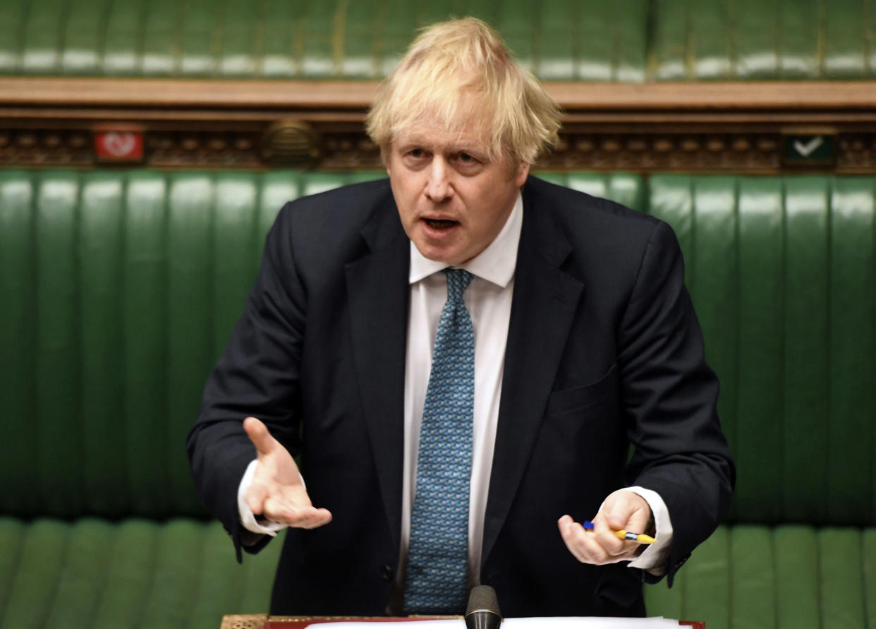 In this handout photo provided by UK Parliament, Britain's Prime Minister Boris Johnson speaks during Prime Minister's Questions in the House of Commons, London, Wednesday, May 13, 2020. (Jessica Taylor/UK Parliament via AP)