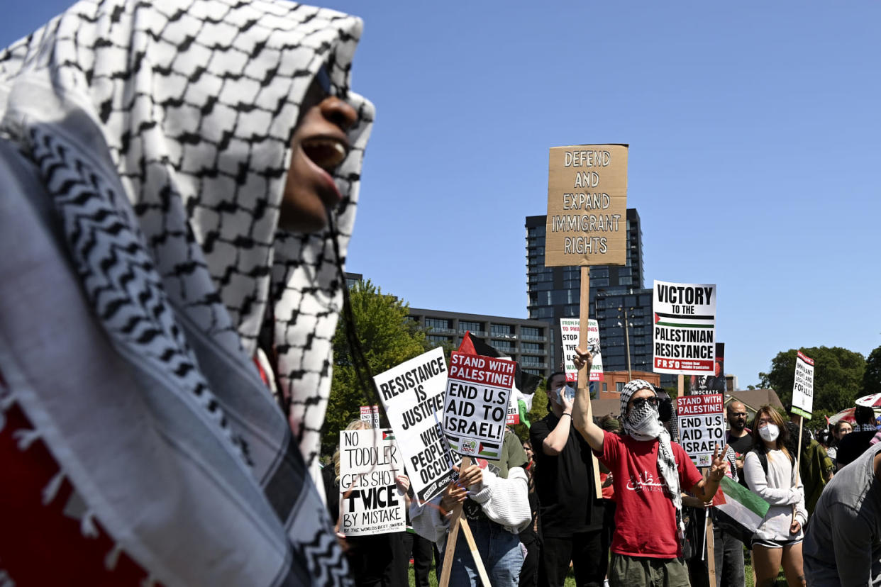 Protesters holding signs gather for a march ahead of the DNC (Noah Berger / AP)