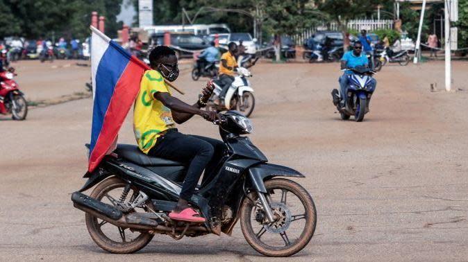 Motorbike rider carries Russian flag