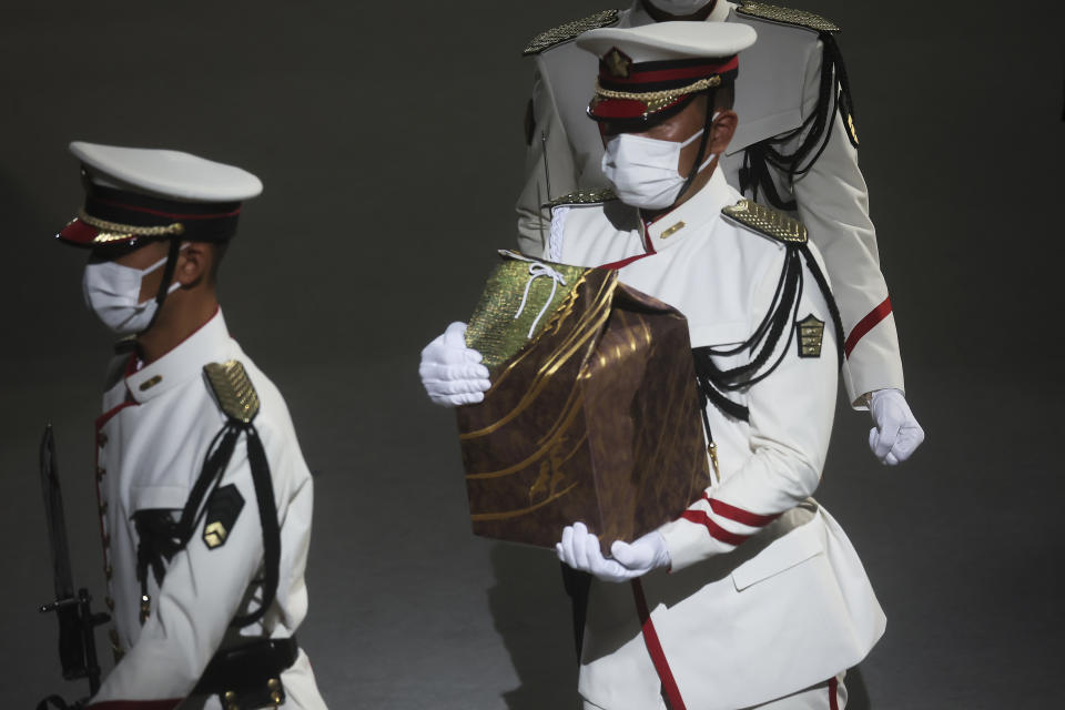 Former Prime Minister Shinzo Abe's urn is brought into his state funeral, Tuesday, Sept. 27, 2022, in Tokyo. Abe was assassinated in July. (Leah Millis/Pool Photo via AP)