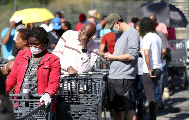 Shoppers queue to stock up on groceries at a Pick n Pay store