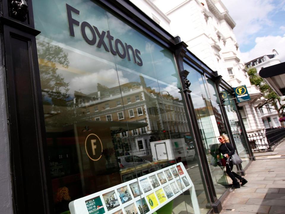 A woman walks into a Foxtons estate agent in west London, Britain July 29, 2016