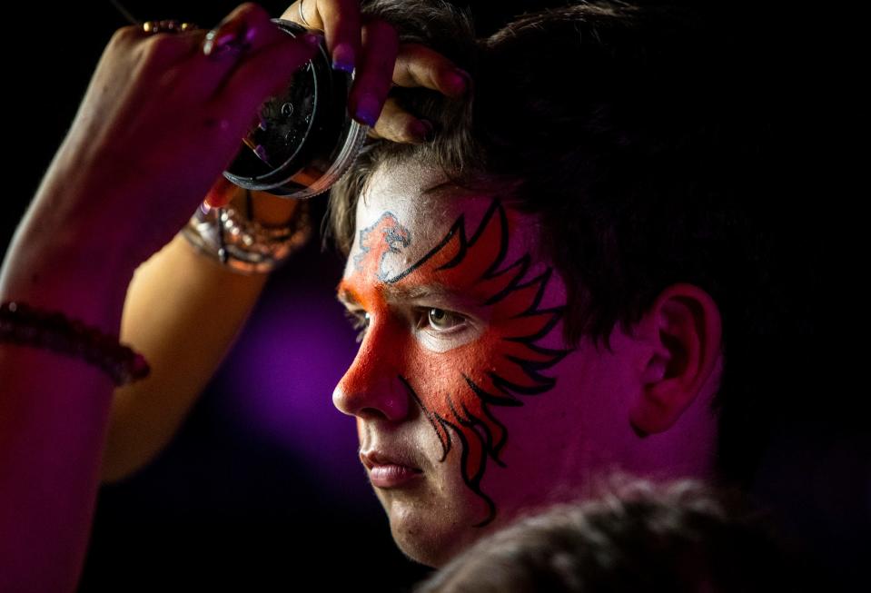 14-year-old Levi Varner of Joshua Tree has a Firebirds logo painted on his face by artist Marisol Israeli Gomez Fontez during a watch party for Game 3 of the Calder Cup Finals at Spotlight 29 Casino in Coachella, Calif., Tuesday, June 13, 2023. 