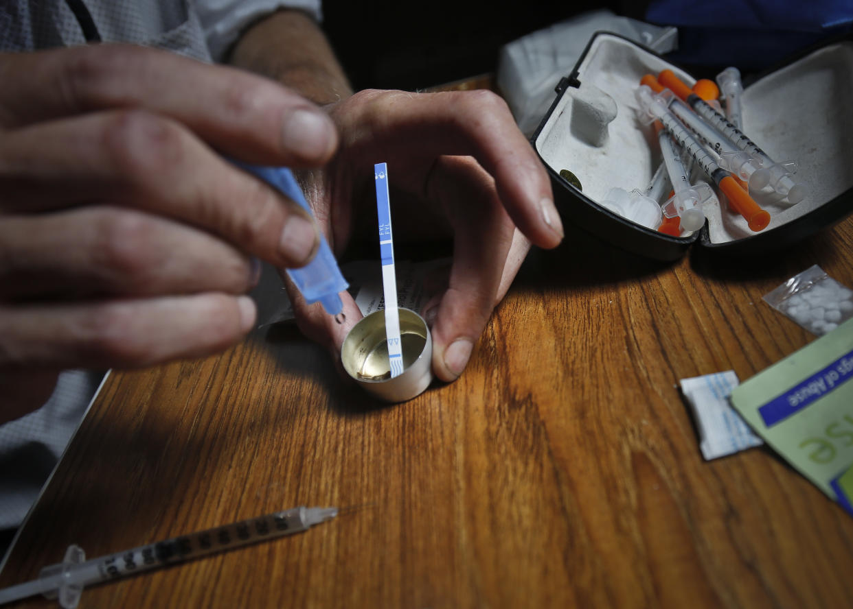 A drug user tests a dose of heroin for fentanyl contamination