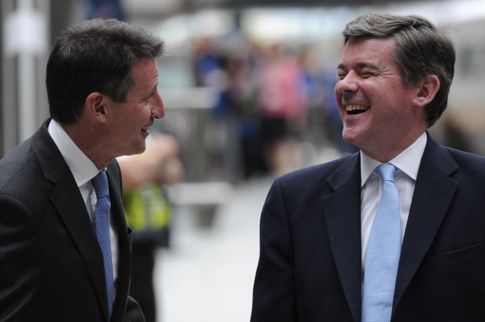 Lord Sebastian Coe (L), Chairman of the London 2012 Organising Committee, and British Sports Minister, Hugh Robertson, share a joke before having their footprints cast in clay at St Pancras International Station in central London, on July 27, 2011. The one-year countdown to the 2012 Olympics got under way on Wednesday with officials bullishly predicting London was on course to deliver the best ever games with 12 months to go. International Olympic Committee chief Jacques Rogge was set to extend a formal invitation to the world's athletes during a 7:00pm ceremony at Trafalgar Square in the culmination of day-long events to mark the one-year milestone. AFP PHOTO / CARL COURT (Photo credit should read CARL COURT/AFP/Getty Images)