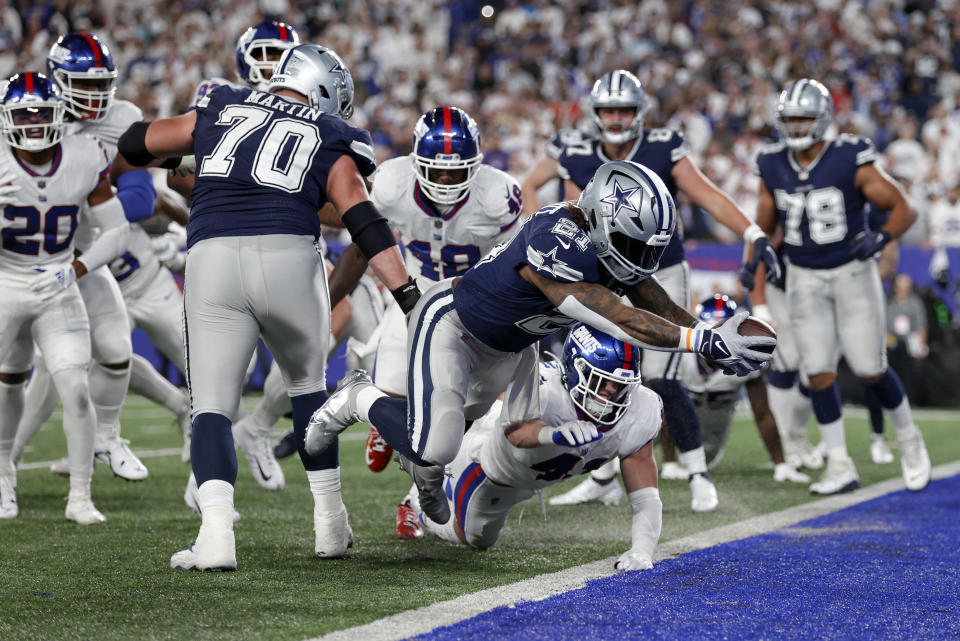Dallas Cowboys running back Ezekiel Elliott (21) leaps across the goal line for a touchdown against the New York Giants during the third quarter of an NFL football game, Monday, Sept. 26, 2022, in East Rutherford, N.J. (AP Photo/Adam Hunger)