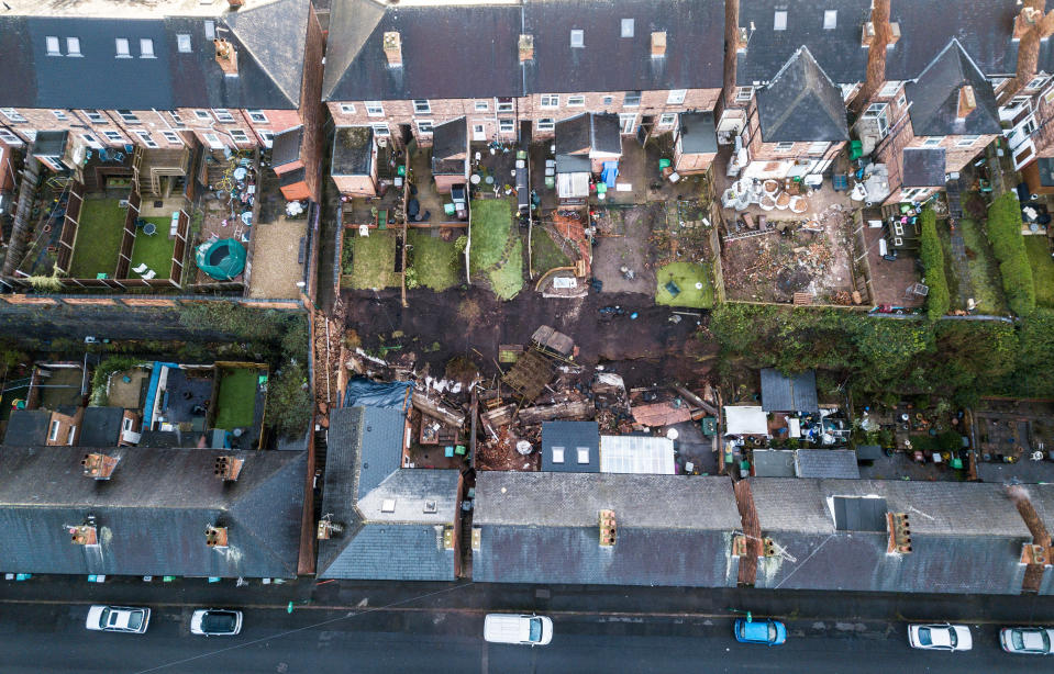 A 70 foot wall has fallen into the gardens of properties in Nottingham after heavy rainfall, February 04, 2021.  Five families were evacuated from their homes in the middle of the night after reports of a 'landslide' in Nottingham.  See SWNS story SWMDwall.  Distressed residents were woken up by the noise of a tonne of bricks, rubble and earth falling into their back gardens of their terraced houses after a 70-foot high wall collapsed.  Nottinghamshire police said five families from four houses had to be evacuated in the pouring rain in Sneinton at 1am on February 3.  Officers arrived at the scene to discover severe damage to their homes, with bathrooms and kitchens flooded.