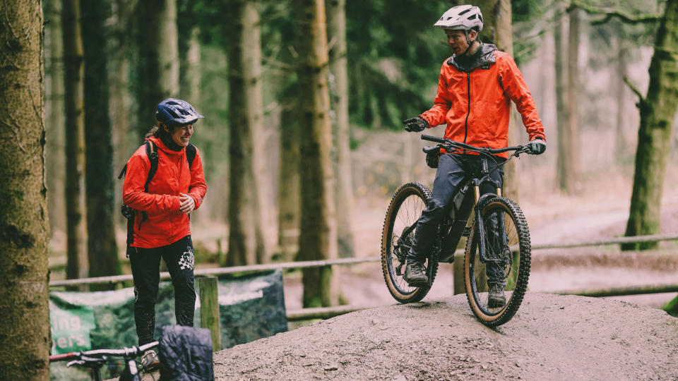 Mountain bike coach Katy Curd laughing with rider