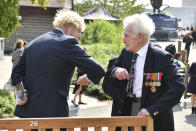 Britain's Prime Minister Boris Johnson greets veteran Bill Redston following the national service of remembrance marking the 75th anniversary of V-J Day at the National Memorial Arboretum in Alrewas, England, Saturday Aug. 15, 2020. Following the surrender of the Nazis on May 8, 1945, V-E Day, Allied troops carried on fighting the Japanese until an armistice was declared on Aug. 15, 1945. (Anthony Devlin/PA via AP)