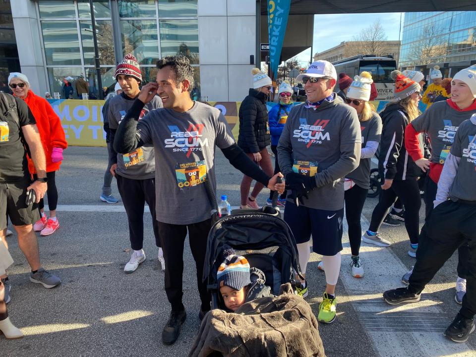 Republican candidate Vivek Ramaswamy engaging with runners with his son in a stroller after the 2023 Des Moines Turkey Trot Nov. 23, 2023.