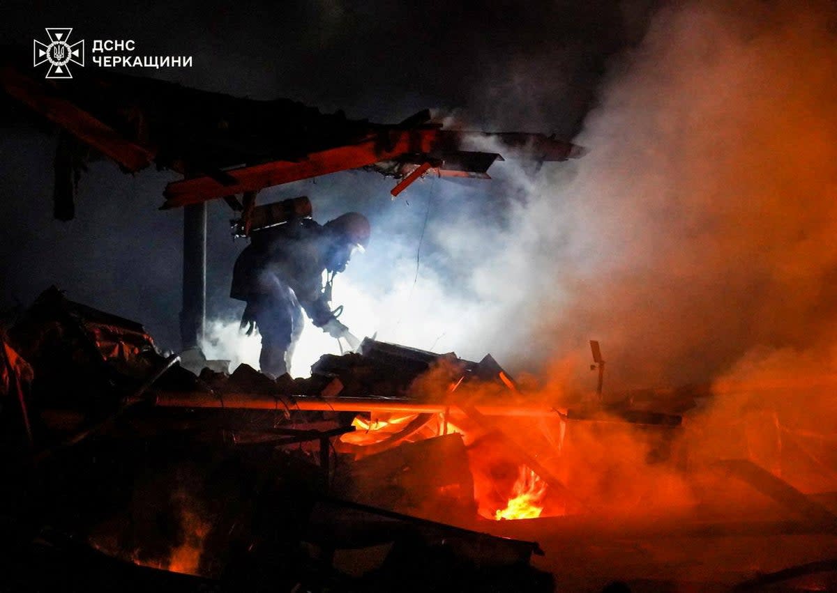 A firefighter works at a site of a Russian missile and drone strike (via REUTERS)