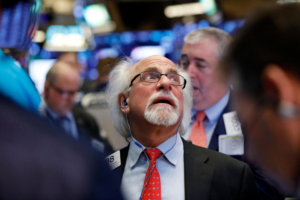 Trader Peter Tuchman works on the floor of the New York Stock Exchange as stocks are opening broadly lower on Wall Street as traders worry about the impact on companies of a slowdown in China's economy.