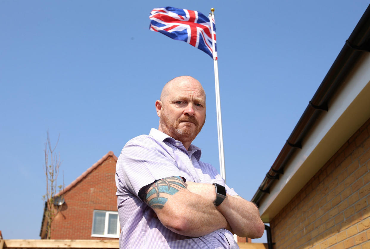 Ex-soldier Andrew Smith, 51, of Nottingham was told by a housing developer to stop flying his Union Jack flag. (SWNS)