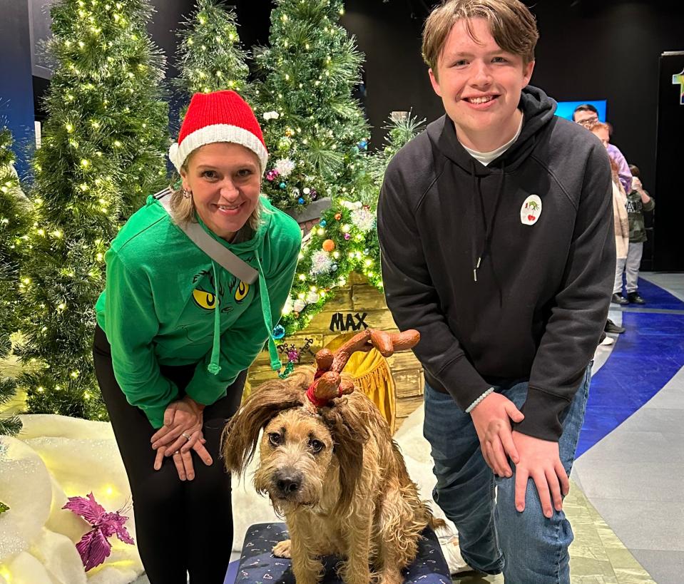 The author and her son posing with a dog with antlers on its head at Universal