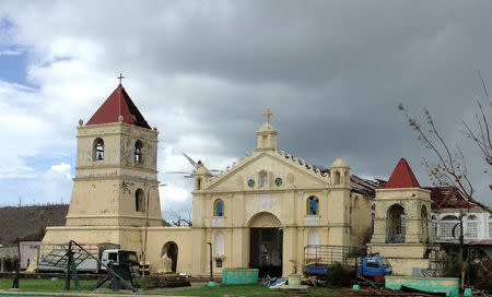 FILE PHOTO: A view of the Roman Catholic church and belfry in the coastal Philippine town of Balangiga after a typhoon, November 20, 2013. REUTERS/Nathan Layne/File Photo