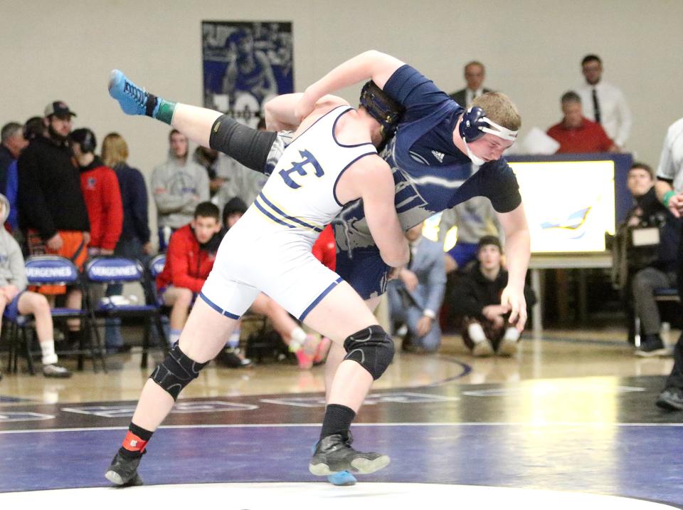 Essex's Chris Folsom throws Fair Haven's Colton Delong to the floor during their match in the finals at the 2023 Vermont State championships on Saturday night at Vergennes High School. Folsom won the match to claim the 220 pound title.