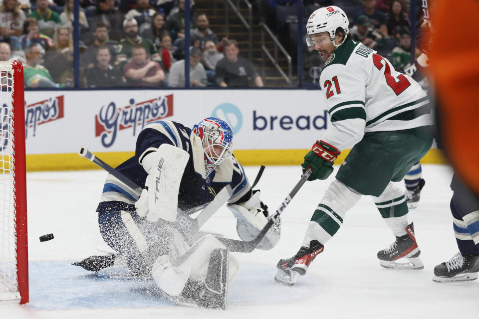 Minnesota Wild's Brandon Duhaime, right, scores a goal against Columbus Blue Jackets' Joonas Korpisalo during the first period of an NHL hockey game Thursday, Feb. 23, 2023, in Columbus, Ohio. (AP Photo/Jay LaPrete)