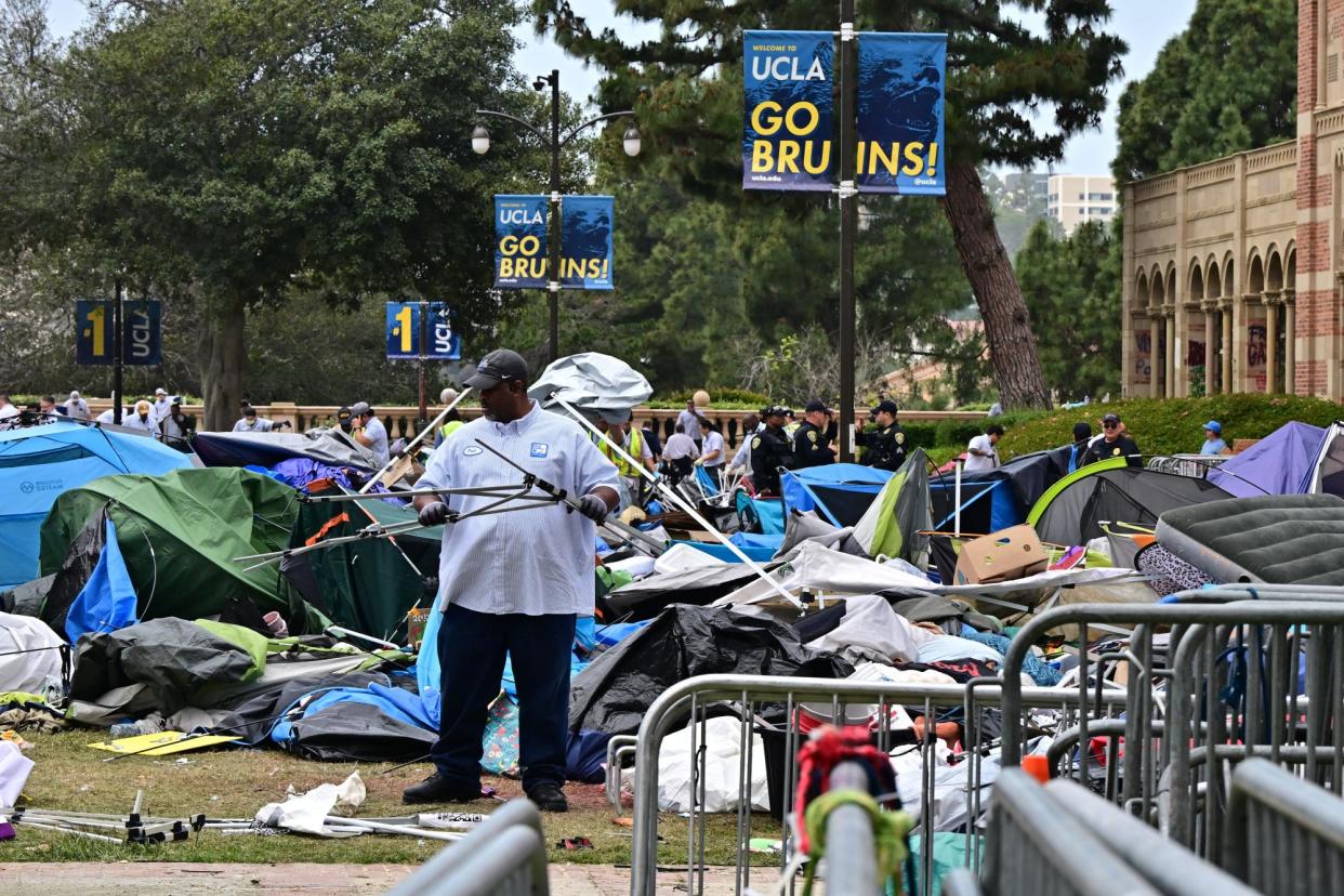 <span>Workers clean up the UCLA campus on 2 May 2024 after police arrested and removed pro-Palestinian students.</span><span>Photograph: Frederic J Brown/AFP/Getty Images</span>