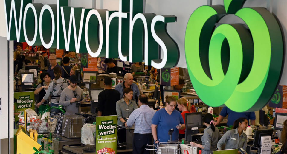Staff and customers at Woolworths store checkouts.