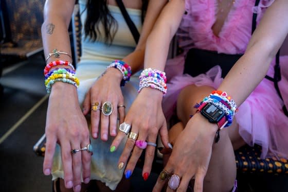 Taylor Swift fans show off their friendship bracelets while riding the Metro Rail to pick up a free shuttle bus to SoFi Stadium to attend Taylor Swift Eras SoFi Stadium tour concert on Aug. 3, 2023.<span class="copyright">Gina Ferazzi—Los Angeles Times/Getty Images</span>