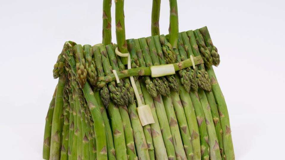 a photo of asparagus birkin bag against a white backdrop