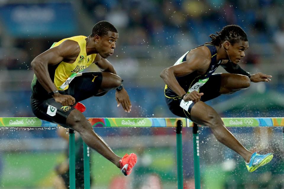 <p>Andrew Riley of Jamaica (L) and Eddie Lovett of Virgin Islands (US) compete during the Men’s 110m Hurdles Round 1 – Heat 3 on Day 10 of the Rio 2016 Olympic Games at the Olympic Stadium on August 15, 2016 in Rio de Janeiro, Brazil. (Getty) </p>