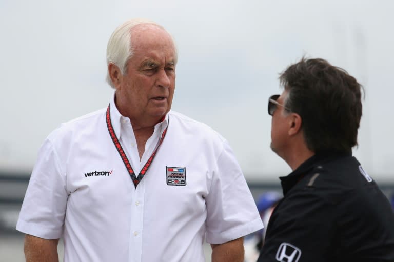 IndyCar team owner Roger Penske, left, talks with rival team owner Michael Andretti, right, who criticized Penske's team in the wake of a cheating scandal that led to a win being stripped from US racer Josef Newgarden (Matt Hazlett)