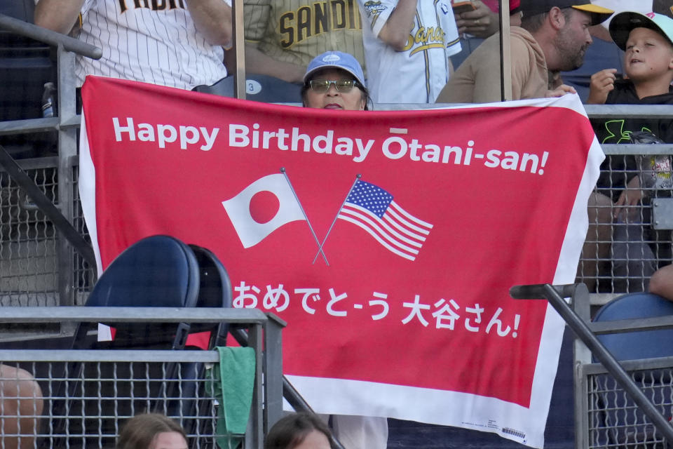 A fan holds a sign for Los Angeles Angels designated hitter Shohei Ohtani during the fifth inning of a baseball game against the San Diego Padres, Wednesday, July 5, 2023, in San Diego. (AP Photo/Gregory Bull)