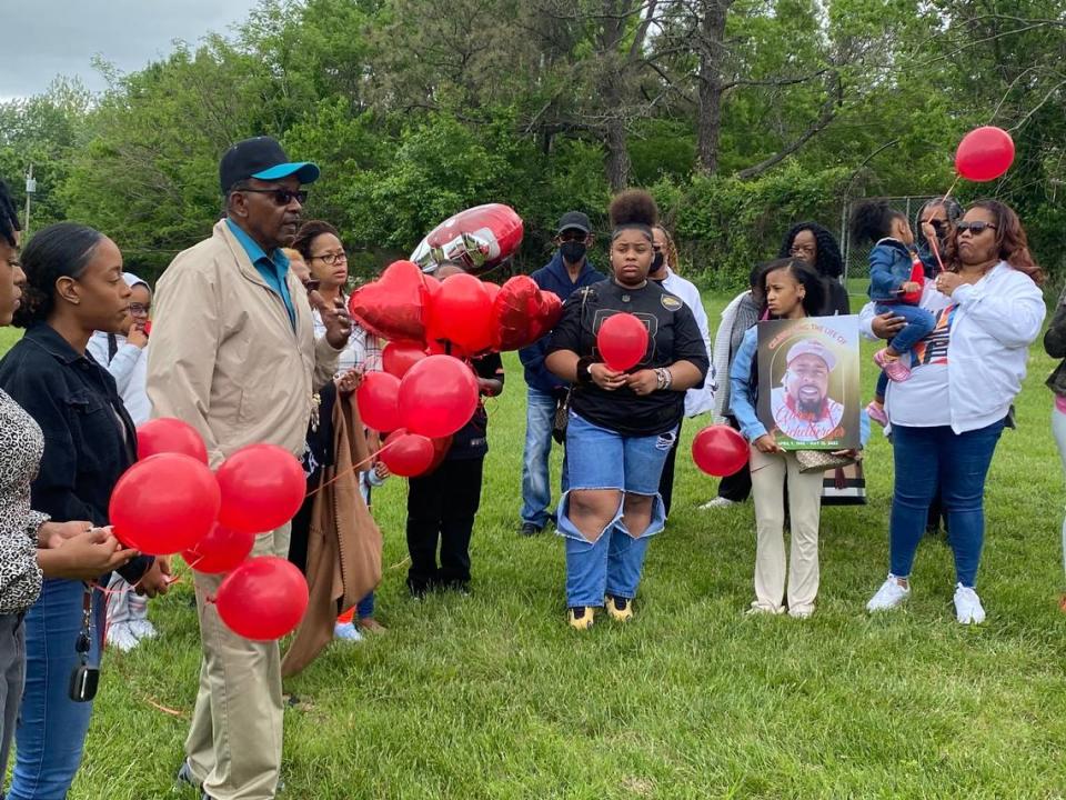 Aaron Eichelberger’s family, including his father, left, gathers at Maple View Park in south Kansas City for a balloon release in his memory. Eichelberger was fatally shot May 14 and found inside a crashed car at 88th Terrace and James A. Reed Road.